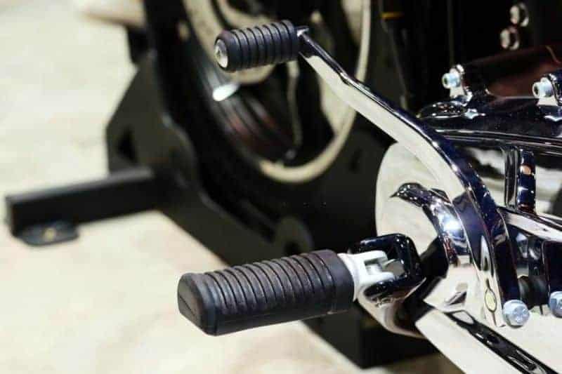 A close up of a motorcycle gear shifter pegs.