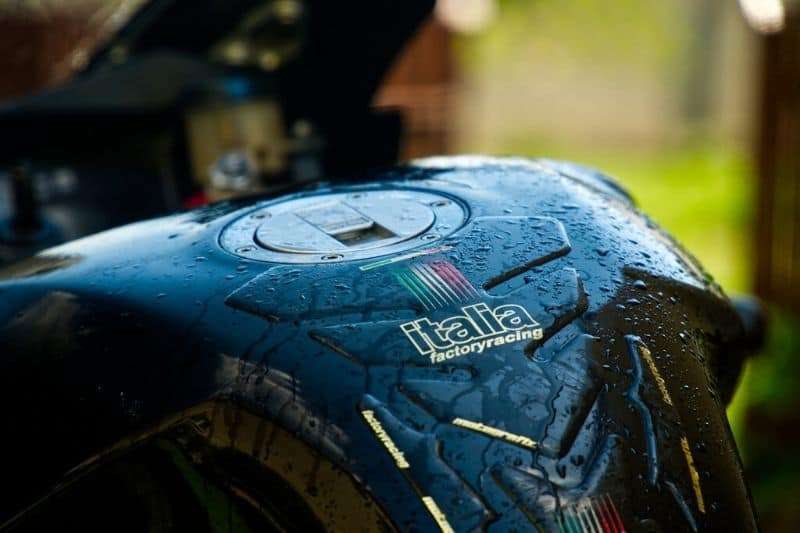 A zoomed in photo of a motorcycle gas tank.
