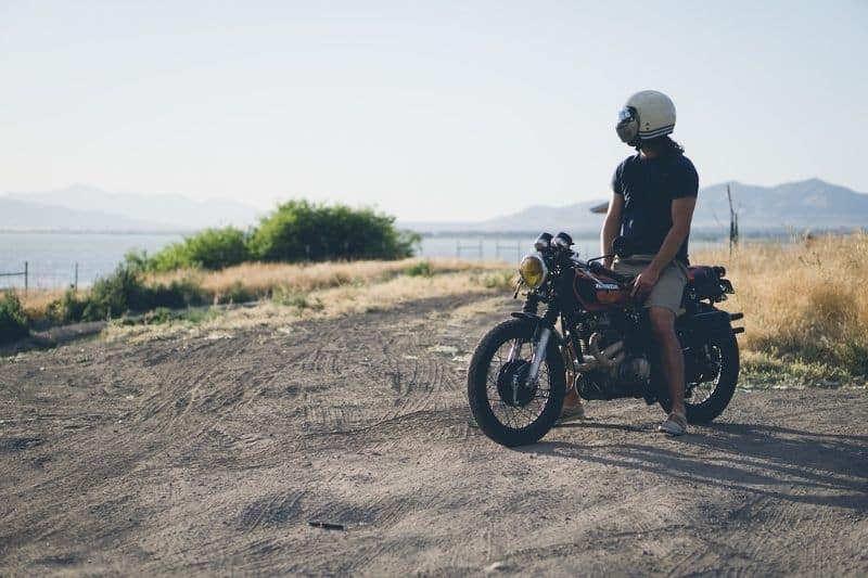 A motorcycle rider sitting on a motorcycle by himself.