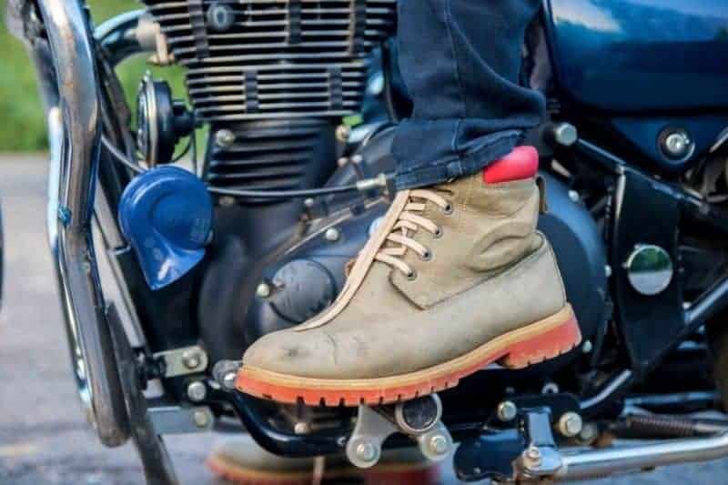 A motorcyclist with hiking boots