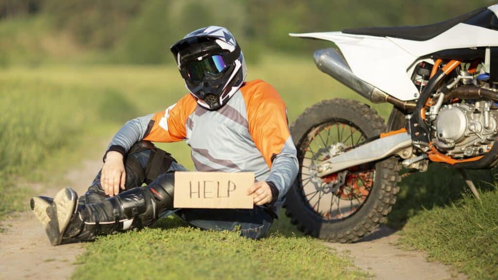 Motorcyclist with a help sign