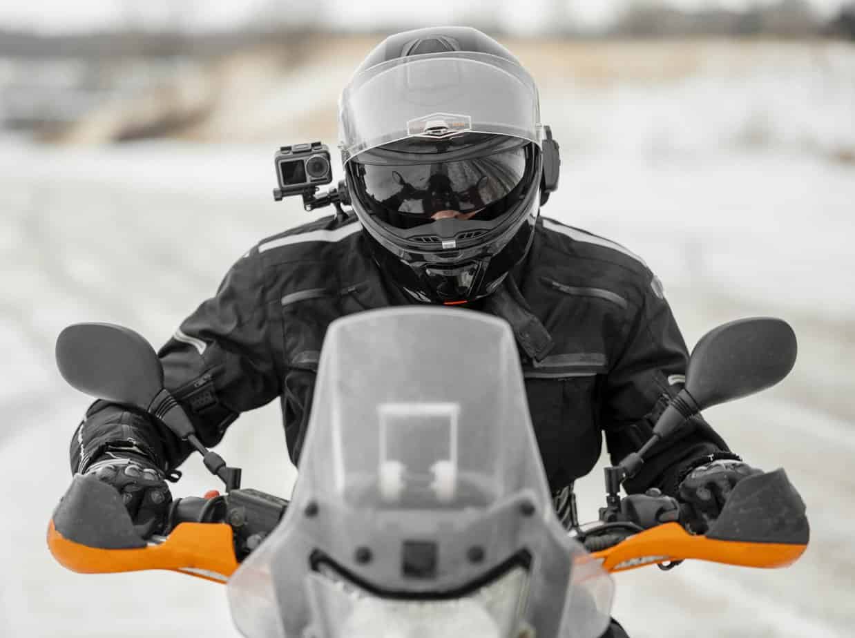 a motorcyclist in snow with a camera on his helmet